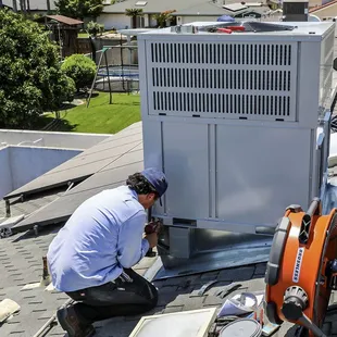 All Climate Air installation technician putting the final touches on a new package unit.