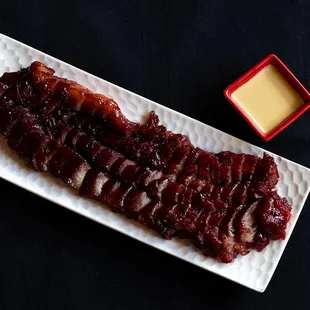 a plate of ribs with sauce