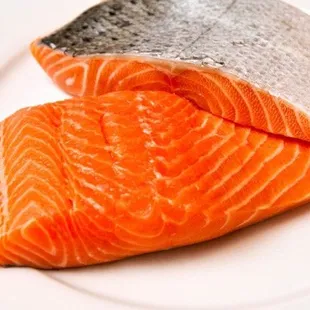 two pieces of salmon on a white plate