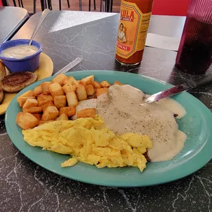 Country fried steak with scrambled eggs and cajun potatoes.