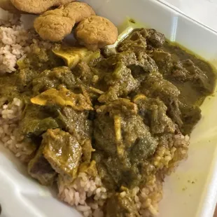 Curry goat with rice &amp; peas, and festival.