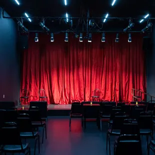 a stage with red curtains