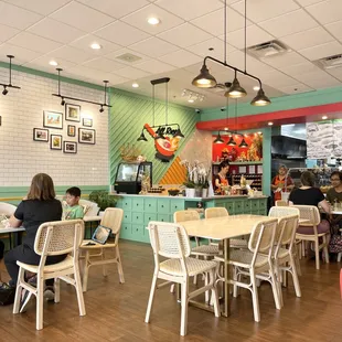 people sitting at tables in a restaurant