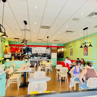 people sitting at tables in a restaurant