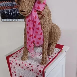 a dog wearing a red hat and scarf