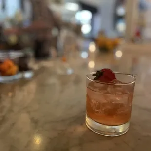 Rhuby Sipper with blanco tequila, rose, clarified strawberry, rhubarb, vanilla, lemon, graham cracker, cinnamon.