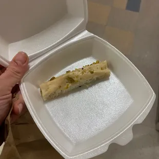 a piece of bread in a styrofoam container