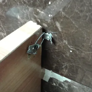 This is how they hold the bathroom dividers on the wall