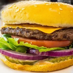 a cheeseburger with lettuce and tomato