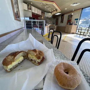 Bacon egg and cheese croissant sandwich, raised sugar doughnut