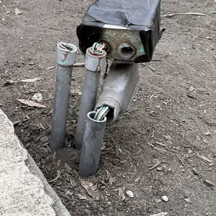 Electrical box or something with exposed wires that doesn't look very safe to be in an area where kids are playing