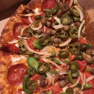 Pizza w/sausage, onions, jalapeño, pepperoni, &amp; peppers.