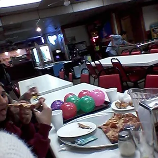 a group of people eating pizza