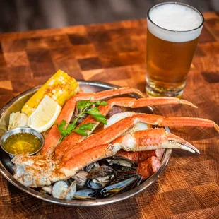 crab legs, mussels, and a glass of beer