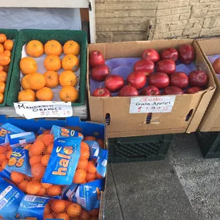 boxes of oranges and apples