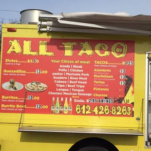 a yellow food truck with a menu