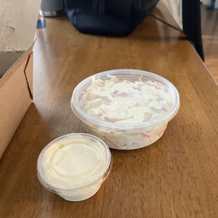 Little cole slaw with a dipping sauce container for perspective.