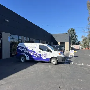 a van parked in front of a building