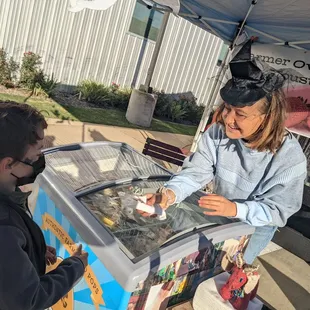 Handing the boy a delicious strawberry popsicle