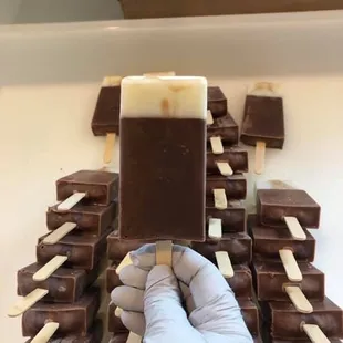 a hand holding a chocolate bar