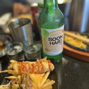 a plate of food and a bottle of beer