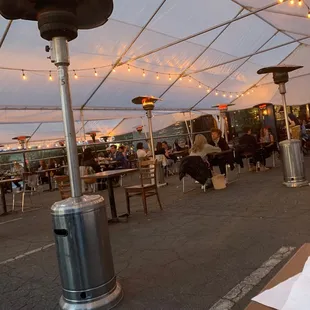 a patio with a lot of tables and chairs