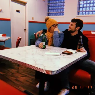 a man and a woman sitting at a table