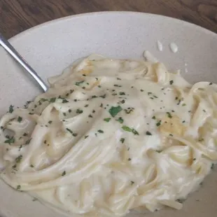 a bowl of pasta with a spoon