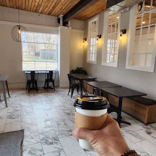 a person holding a cup of coffee