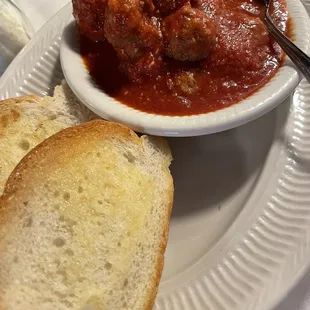 a bowl of soup and bread on a plate