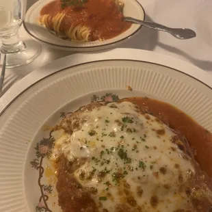 a plate of lasagna and a glass of water