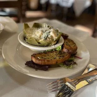Cheese and spinach dip with rock shrimp in an artichoke bowl