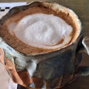 Standard cappuccino with whole milk served in locally made mug