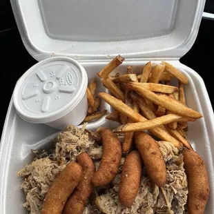 Barbecue plate with hush puppies, baked beans, and fries