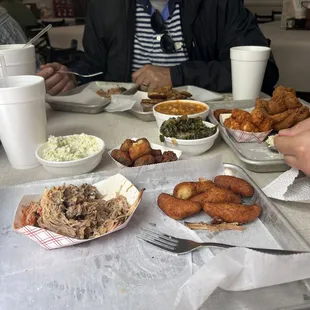 Catfish Plate, bbq pulled pork, hush puppies, Cole slaw, collard greens