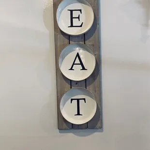 three bowls with the word eat on them