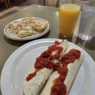 Breakfast burrito with added salsa and biscuits and gravy.