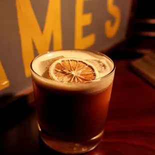 a glass of beer with a slice of lemon