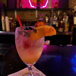 a drink in a glass on a bar