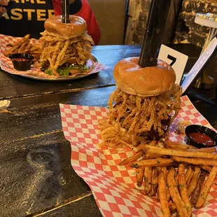 two plates of pulled pork and fries