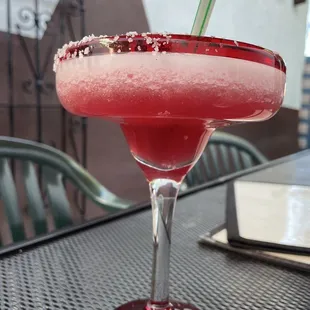 a pink drink with a straw