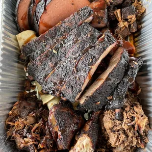 ribs, potatoes, and meat in a container