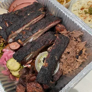 a tray of meat and sides