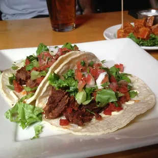 Seitan tacos and buffalo tofu in the background.