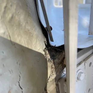 Strip not really attached to the wall, hole in the stucco.