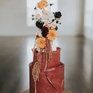 a red cake with flowers on top