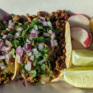 a plate of tacos and a pickle