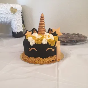 a cake with a unicorn on top