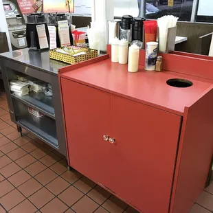 a counter with a red cabinet