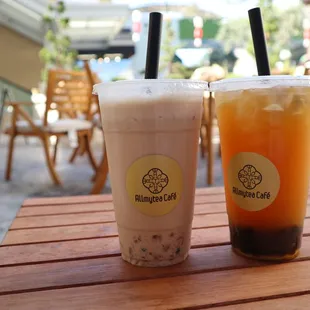 Outdoor table with Hokkaido Milk Tea with Crystal Boba, and Passion Island Tea with Boba.